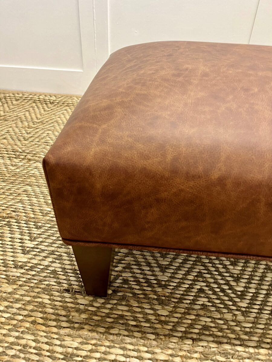 Delcor-bespoke-luxury-footstool-meticulously handcrafted in Britain-choose from over 10,000 fabrics-including velvets-leathers-vast array of patterned and plain materials-available in a broad spectrum of colours-including grey-cream-blue-purple-red-green-and more-each piece showcases timeless design and comfort.